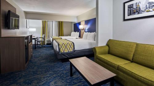 a hotel room with a bed and a couch at Best Western Knoxville Airport / Alcoa, TN in Alcoa