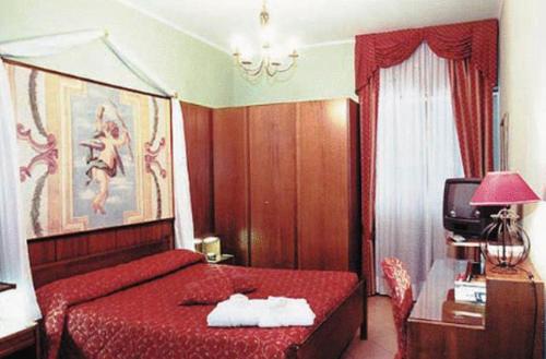 a bedroom with a red bed with a red bedspread at Hotel La Bussola in Cittiglio