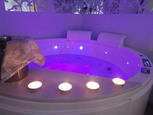 a purple bath tub with lights in a room at Blue House Varenna in Varenna