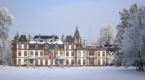 a large building covered in snow in a field at Château de Pourtalès in Strasbourg