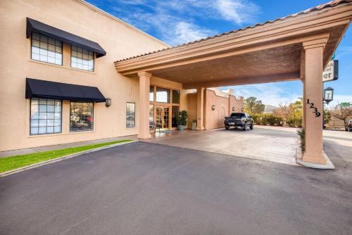 a garage with a car parked in front of a building at Clarion Suites St George - Convention Center Area in St. George