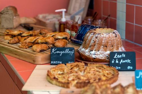 a counter with various types of bread and pastries at Hôtel Tandem - Boutique Hôtel in Strasbourg