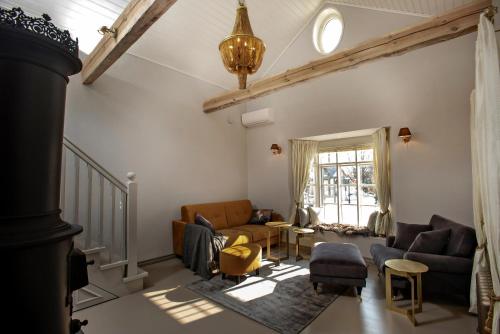 a living room with a couch and chairs and a window at Lilla Sand in Porvoo