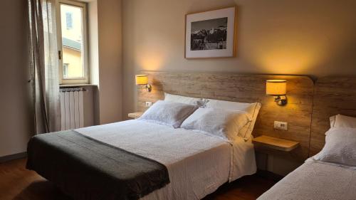 a bedroom with a large bed and a window at Il Sole in Bergamo