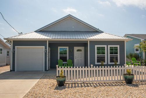 a house with a white fence in front of it at Beach Daze in Panama City Beach