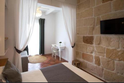 Televisor o centre d'entreteniment de My Rooms Ciutadella Adults Only by My Rooms Hotels TI