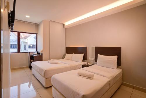 a hotel room with two beds and a window at GM Metro at Sunway in Petaling Jaya