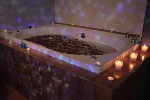 a large bath tub with candles in a room at Hotel Plaza Delta in Mexico City