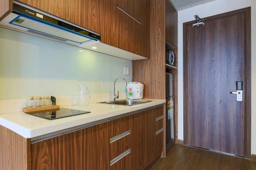 a kitchen with a sink and a counter top at Aurora Serviced Apartments in Ho Chi Minh City