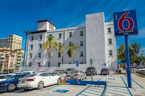 a parking lot with cars parked in front of a building at Motel 6-San Diego, CA - Downtown in San Diego