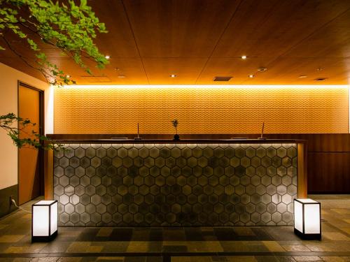 a lobby with a wall with lights on it at Hotel Gracery Kyoto Sanjo in Kyoto