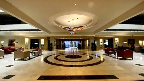 a lobby with a large lobby with a hotel at Safir Fintas Hotel Kuwait in Kuwait