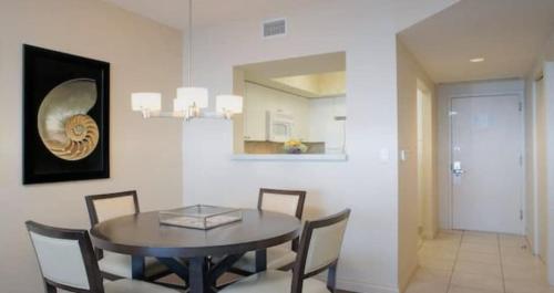 a dining room with a table and chairs and a mirror at Best Resort Beach Front Condo in Miami Beach