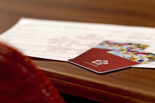 a passport sitting on top of a wooden table at Hotel Gran Ms Kyoto in Kyoto