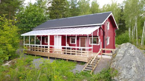 a red house with a black roof at Lomahyppäys in Naantali