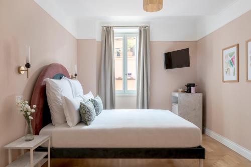 a bedroom with a large white bed with a window at Numa I Portico in Rome