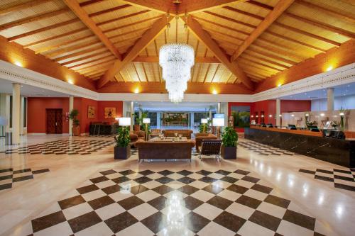 a large lobby with a checkered floor at Valentin Sancti Petri in Chiclana de la Frontera