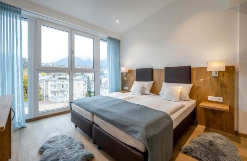 Voodi või voodid majutusasutuse AVALON Hotel Bad Reichenhall toas