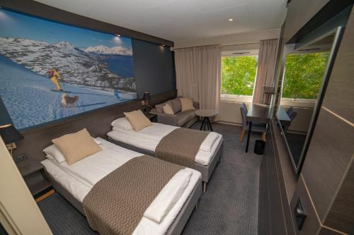 een hotelkamer met 2 bedden en een schilderij aan de muur bij Hotell Maritim Skjervoy in Skjervøy