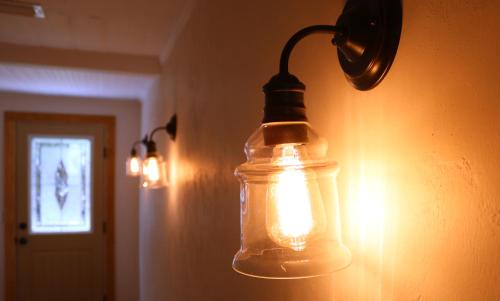 a glass jar hanging on a wall with lights at Sweetwater Branch Inn in Gainesville