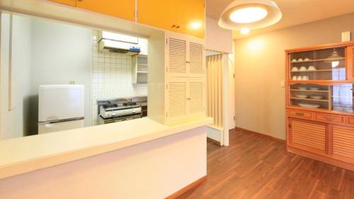 a kitchen with a refrigerator and a counter top at Izu Ippeki lake Side Terrace - Vacation STAY 32475v in Ito