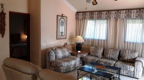 a living room with a couch and a table at La Quinta Villas in San Miguel de Abona