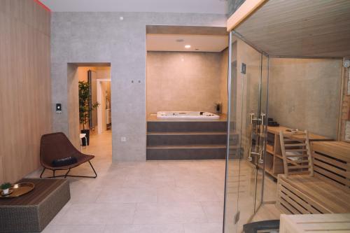 a room with a bath tub sitting on the wall at Luxury wellness apartment SHA in Osijek