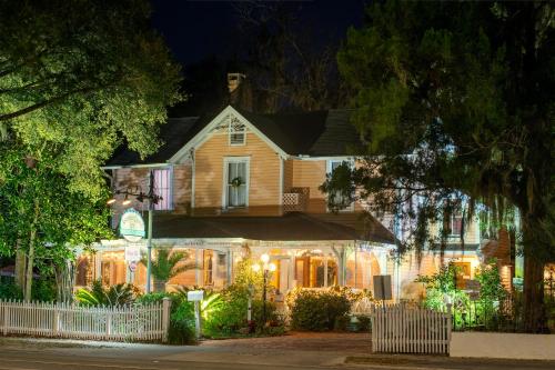 a house decorated with christmas lights at night at Sweetwater Branch Inn in Gainesville