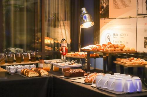 a table with various types of bread and pastries at HANNONG Hotel & Wine Bar in Strasbourg