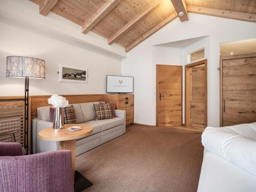 a living room with a couch and a table at Hotel Magdalena Mayrhofen in Mayrhofen