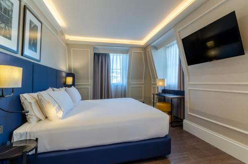 a hotel room with a bed and a tv at Eurostars Lisboa Baixa in Lisbon