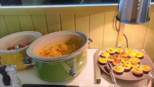 a pot of food sitting on a stove with deviled eggs at Ibis Styles Lisboa Centro Marquês de Pombal in Lisbon