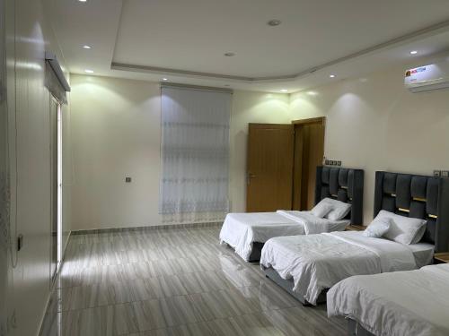 a hotel room with two beds in a room with at فيلا قمرية الهدا in Al Hada