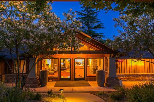 a house with glass doors and trees at night at Driftwood Lodge in Springdale