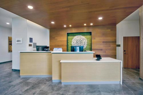 a lobby with two counters and a painting on the wall at Fairfield by Marriott Inn & Suites Cincinnati North West Chester in West Chester