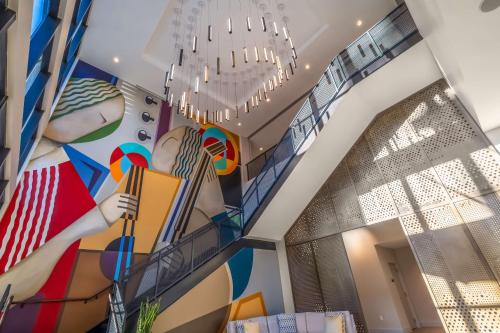 a room with a mural of a woman playing a accordion at Hyatt Place Gainesville Downtown in Gainesville