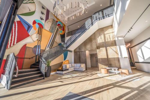 a staircase in a building with a mural on the wall at Hyatt Place Gainesville Downtown in Gainesville