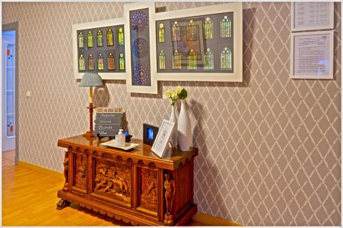 a room with a table and some stained glass windows at Luengo House in León