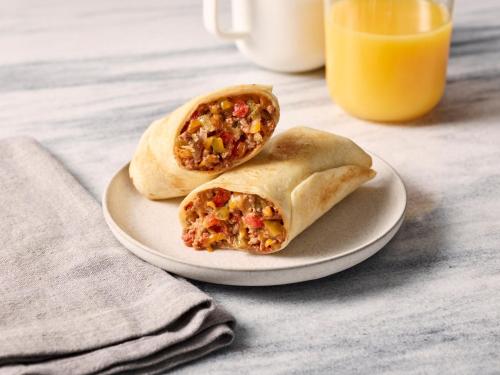 two breakfast burritos on a plate with a glass of orange juice at Residence Inn by Marriott Harrisburg Carlisle in Carlisle