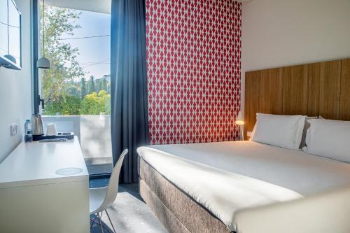 A bed or beds in a room at Stay Hotel Lisboa Aeroporto