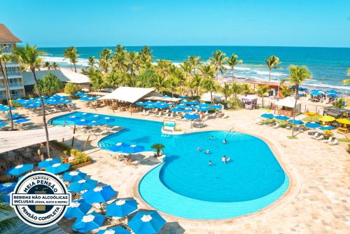 an aerial view of a resort with a pool and the ocean at Gran Hotel Stella Maris Urban Resort & Conventions in Salvador