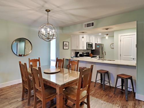 a kitchen and dining room with a table and chairs at Edgewater Villa 2406 in Panama City Beach