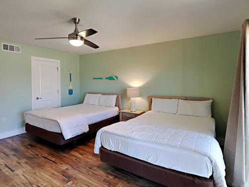 a bedroom with two beds and a ceiling fan at Edgewater Villa 2406 in Panama City Beach