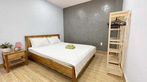 1 dormitorio con cama y escalera de madera en Vania House comfortable studio near the airport, en Ho Chi Minh