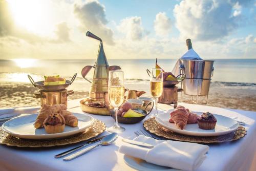 a table with food and drinks on the beach at Sarova Whitesands Beach Resort & Spa in Mombasa