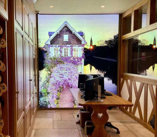 a room with a picture of a house on the wall at Hotel Beaucour in Strasbourg