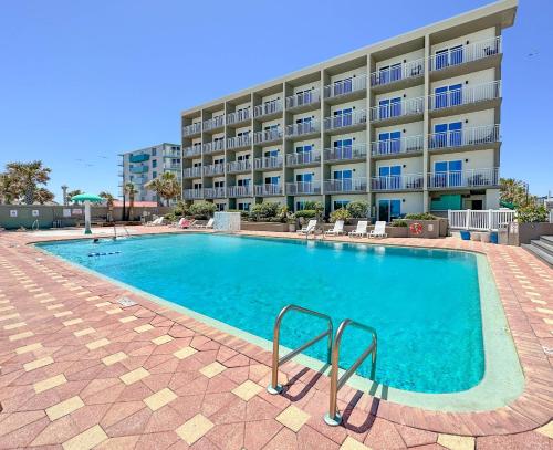 a large swimming pool in front of a building at Boardwalk Inn and Suites in Daytona Beach