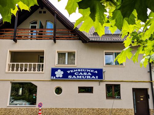 ein Gebäude mit einem Schild für einen Autosalon in der Unterkunft Pension Casa Samurai in Braşov