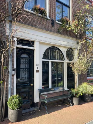 a bench in front of a house with a door at Villa360 in Amsterdam