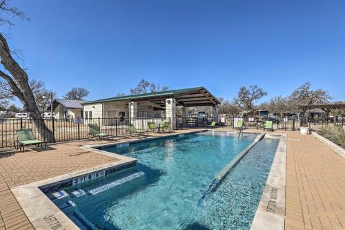 a swimming pool in front of a house at Community Pool and Hot Tub Austin Tiny Home! in Austin